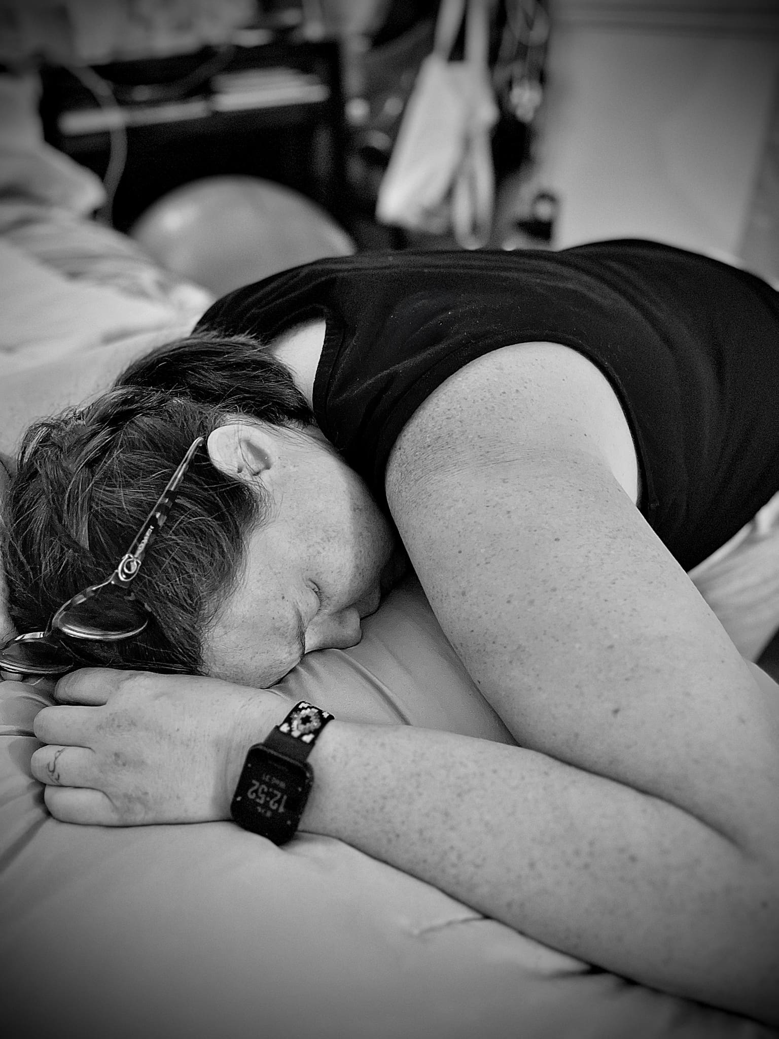 Tifton birth photographer homebirth after preterm premature rupture of membranes: laboring Mom lays facedown on a bed, watch shows 12:52 AM