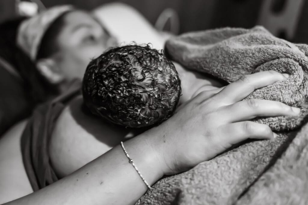 why birth photography: mother nursing her newborn during the golden hour directly after birth