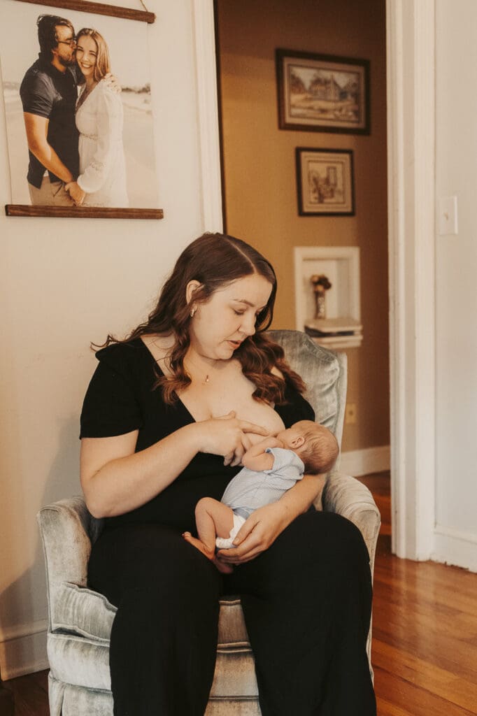 Tifton, GA mother breastfeeding newborn at home during early postpartum recovery by birth and motherhood photographer Sarah John Photography
